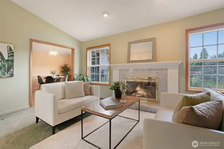 A classic marble fireplace with detailed mantel serves as the elegant focal point.