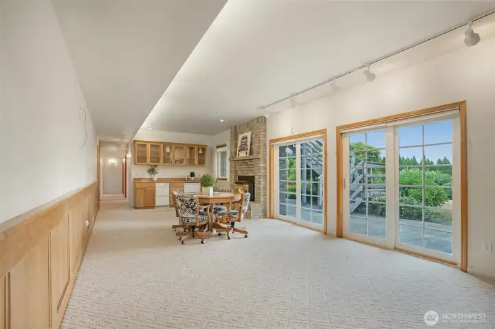 Slider opens to the lower yard for seamless indoor-outdoor flow, and the nearby wet bar makes hosting a breeze. Endless possibilities for fun, function, or multi-generational living