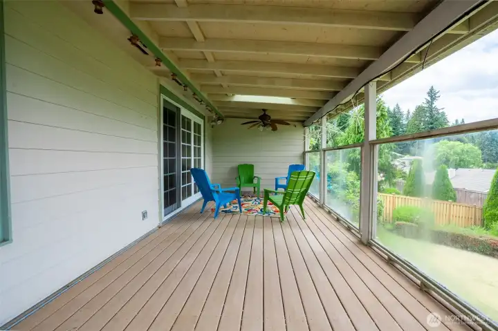 Enjoy the outdoors year-round from this expansive covered deck, perfectly positioned off the family room and dining room for seamless indoor-outdoor living. Overlooking peaceful lake views and the lush backyard.  With room for seating and string lights already in place, it's a private perch for every season.”