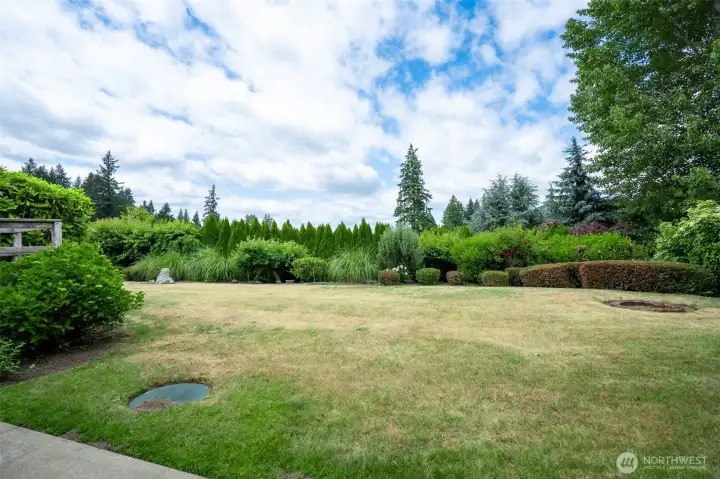Set on a generous .42-acre lot, this beautifully landscaped yard offers privacy, space, and serenity. Mature hedges and lush plantings frame the fully usable lawn, creating a natural sanctuary perfect for pets, play, or garden parties.