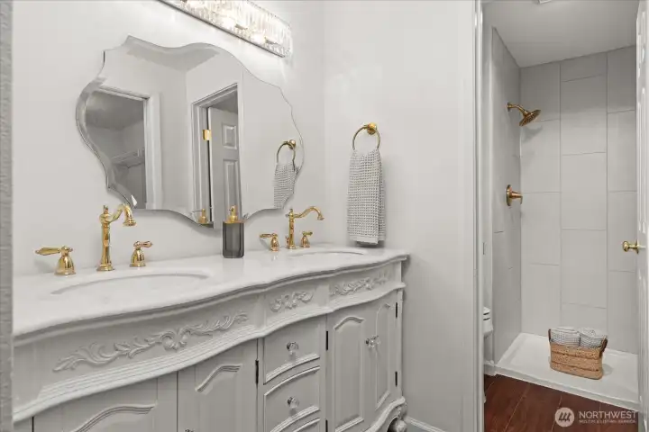 Custom vanity with dual sinks and separate shower and toilet room, with new, beautiful tiled shower and brushed gold faucet