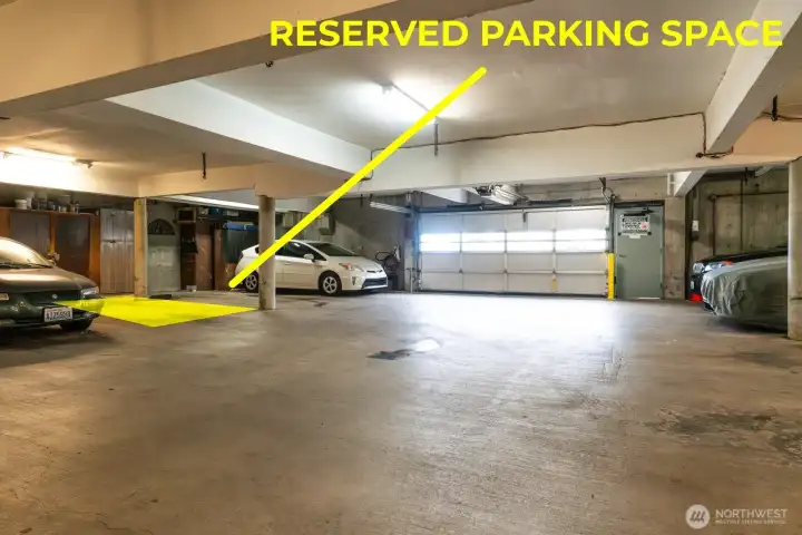 Secure parking space in community garage with additional storage behind parking space