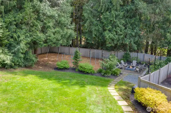 The fully fenced yard has a firepit and outdoor gym.