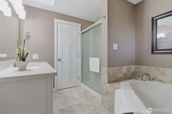 Main bathroom has a soaking tub and separate shower