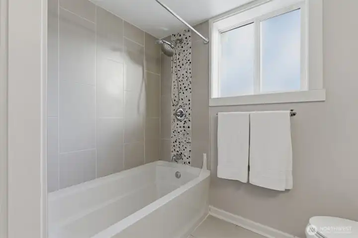 Soaking tub and shower to lower level bath