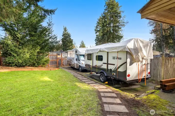 Stone walkway lines the back driveway