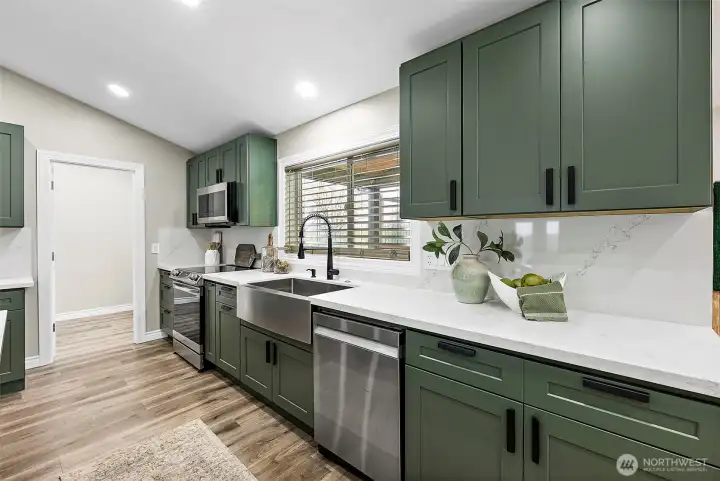 Thoughtfully designed with ample storage and counter space as well as a deep stainless farm sink and commercial style faucet.