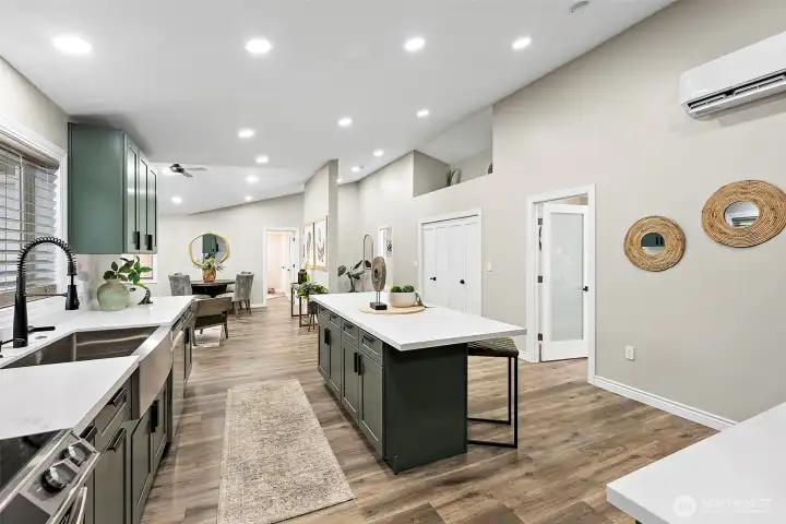 Kitchen connects to the hall with the laundry closet, main bathroom and artwork display area above.