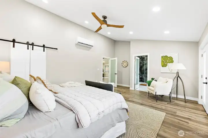 Barn doors into the large walk in closet on one side, french doors on the other with the private bathroom in the center.