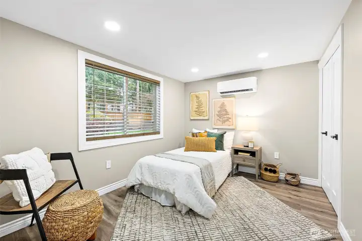2nd bedroom on main floor with its own HVAC mini-split and cable port on the wall.  (room can fit a queen but was staged with a twin)