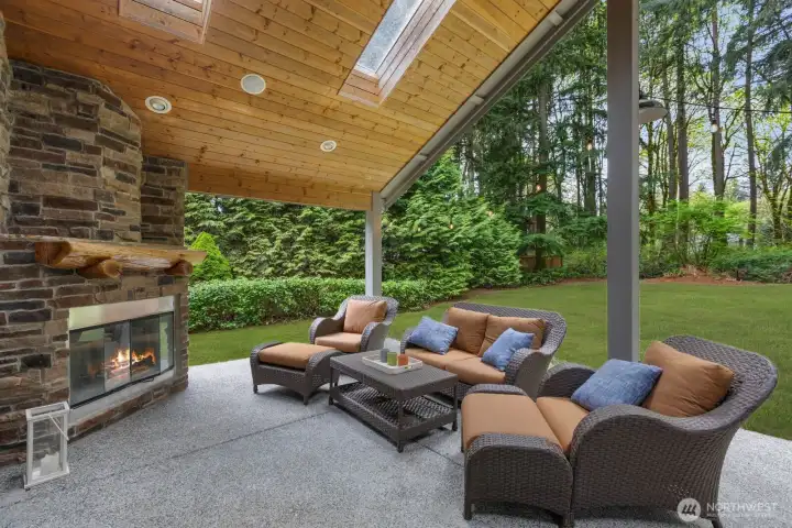 Covered patio with a statement fireplace for year round enjoyment.