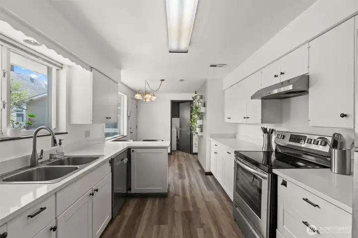 Kitchen from dining area towards eating space and laundry
