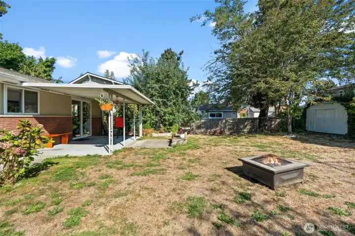 Back yard looking from back of garage towards house
