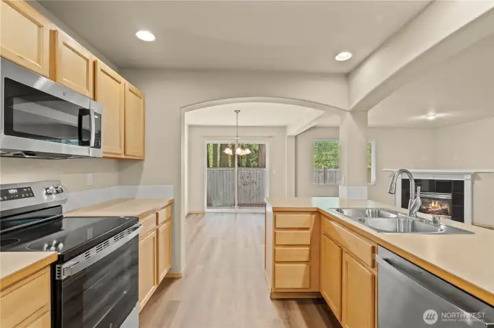 KITCHEN w/Maple Cabinets, White Tile Backsplash, Recessed Lighting (on dimmer), Dual Basin Stainless Steel Sink w/New Faucet.