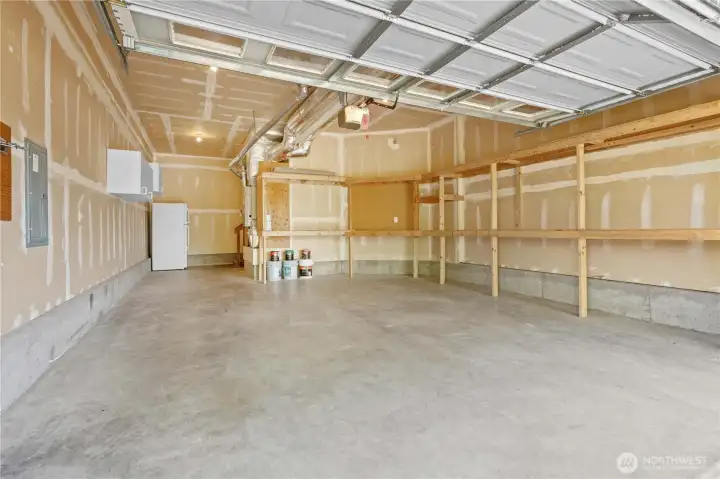 GARAGE: 2-Car Garage w/Built-In Shelving and Extra Shop Space. Garage Door Opener, too!