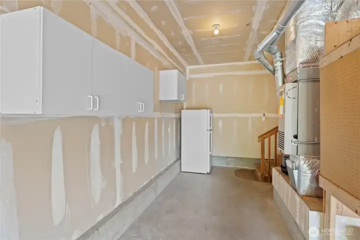 GARAGE: Shop Space w/Extra Garage Fridge, Cabinets, Bryant Gas Furnace (just serviced) and Rheem Water Heater (replaced 2021)