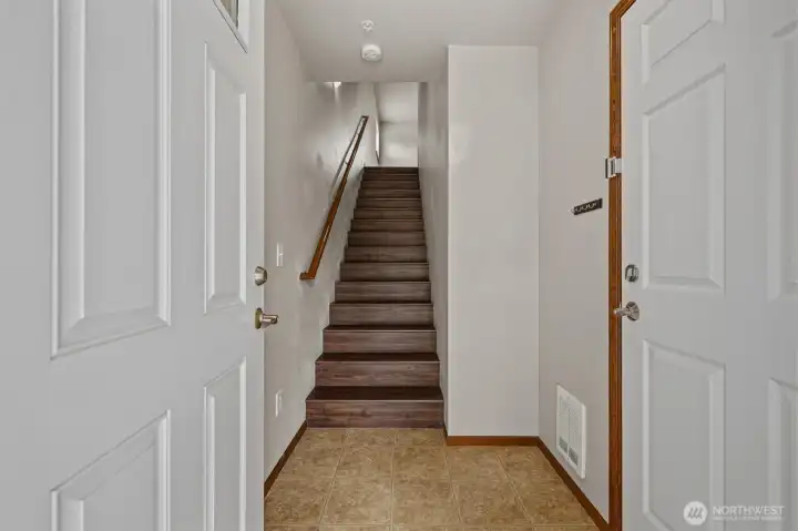 Main floor entry, garage door, and stairs leading up to the 2nd floor. Main floor entry, garage door, and stairs leading up to the 2nd floor.