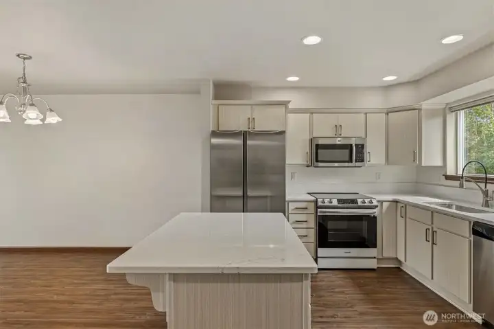 Updated kitchen with quartz countertops. New Range and refrigerator. Updated kitchen with quartz countertops. New Range and refrigerator.