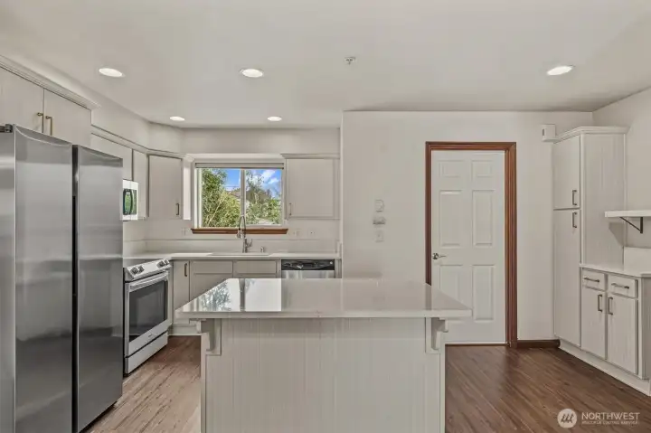 Updated kitchen with quartz countertops. New Range and refrigerator. Updated kitchen with quartz countertops. New Range and refrigerator.