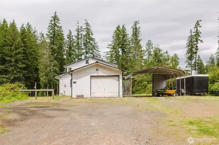A great setup for hobbyists and outdoor enthusiasts alike! The property features a one-car garage with 220-volt service, a two-car metal carport for additional covered parking, and a 50-amp RV hookup ready for your next adventure. A great setup for hobbyists and outdoor enthusiasts alike! The property features a one-car garage with 220-volt service, a two-car metal carport for additional covered parking, and a 50-amp RV hookup ready for your next adventure.
