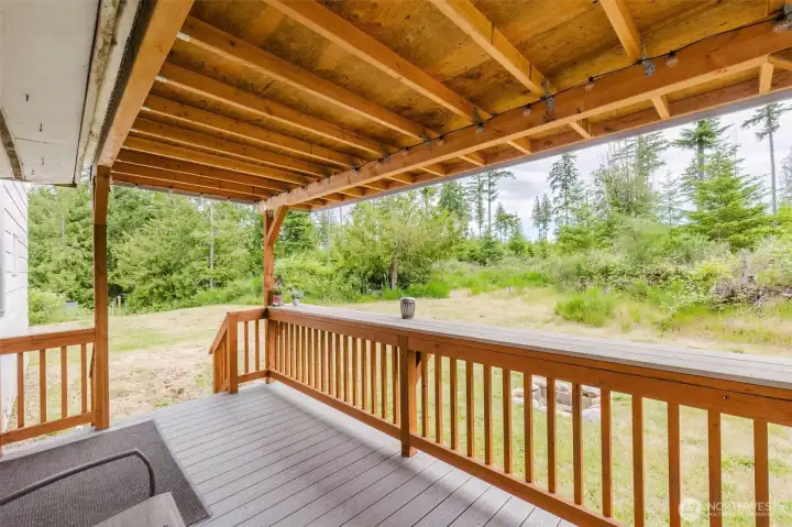 Outdoor living shines with a covered Trex-style back deck, covered side porch, paver walkways, patio, firepit, picnic area, and multiple outbuildings. Outdoor living shines with a covered Trex-style back deck, covered side porch, paver walkways, patio, firepit, picnic area, and multiple outbuildings.