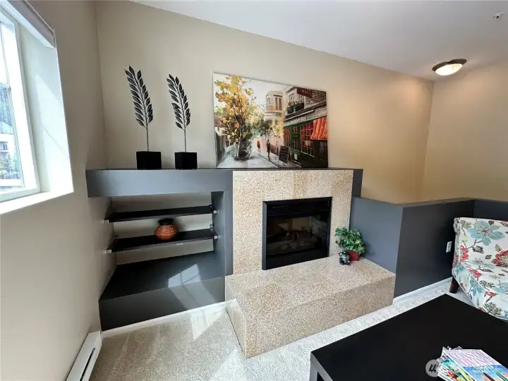 Cozy fireplace with tiled surround, unique shelving and ways to store or show your favorite pieces.