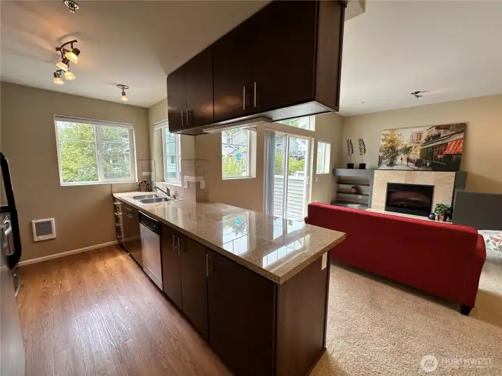 Check out this kitchen! Shinning granite tiled counters and lots of cabinets!