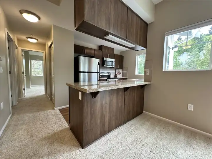 Don't miss the ease and convenience of having this breakfast bar! Hallway to the laundry, full bathroom and bedroom.