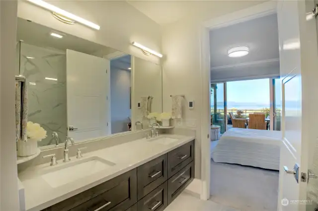 Floating vanity, double sinks, sleek modern light fixtures.