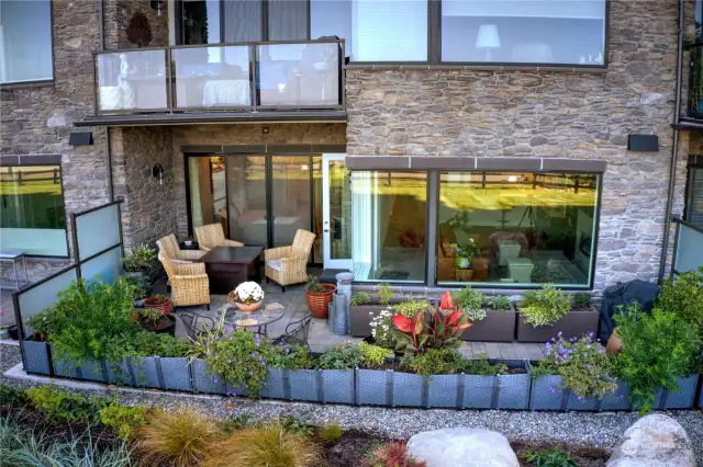 Beautiful container garden added to create more intimate patio oasis.