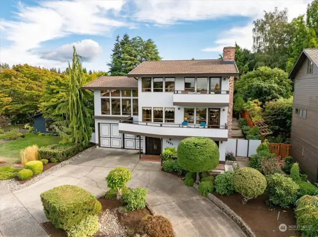 Greenery and a circular driveway front this home, one filled with ingenious architecture and accessible touches.