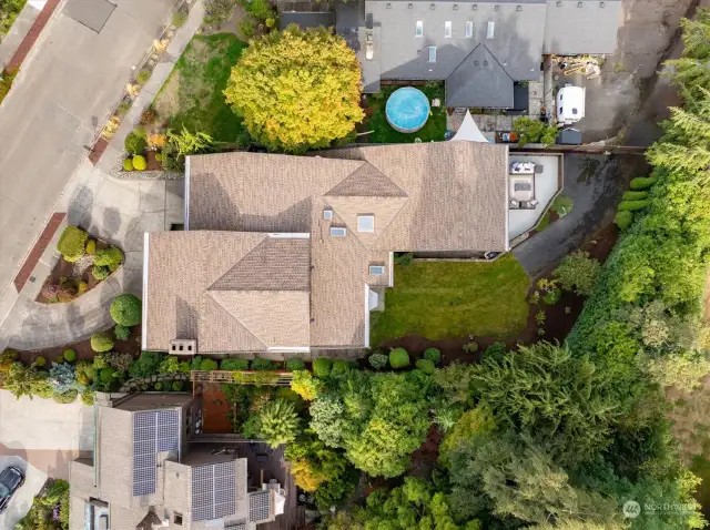 As above, so below! The view from up to demonstrates the home’s grand scale as well as the multiple access points. While guests arrive via the elegant circular driveway, deliveries and the like can be neatly executed by the back alley.