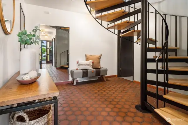 One step inside sets the tone for a design-filled existence. FInd a tiled entrance, centering spiral staircase, and intuitively flowing floorplan.