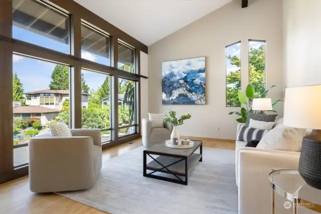 The living room both evokes and delivers space, courtesy of airy vaulted ceilings and a wall of view-friendly windows.