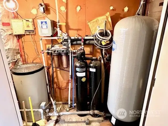 Mechanical room with pressure tank, water softener, & filters.