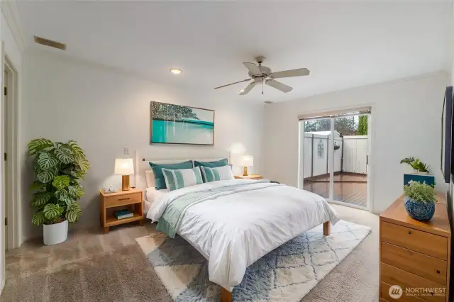 Primary suite is spacious and offers a private ensuite bathroom. Slider door for access to the massive deck and hot tub.