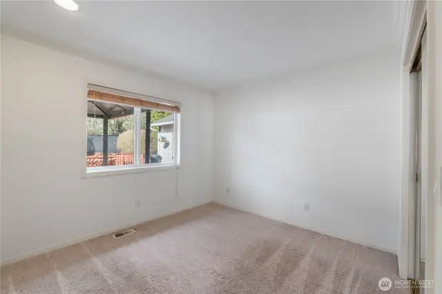 Guest bedroom offers views of the backyard and overlooks the deck.