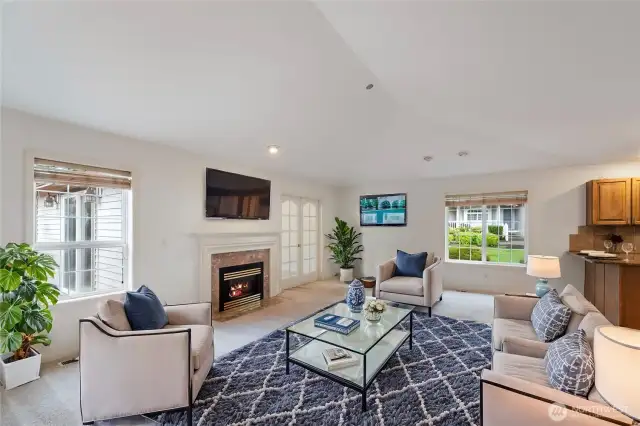 The living room is spacious and filled with natural light. The gas fireplace is a great place to curl up and read a book.