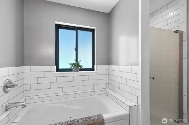 The bath has a large jetted tub and separate shower.