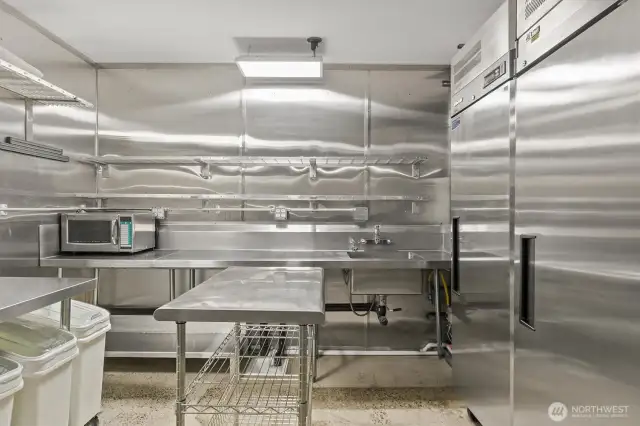 The side prep area has 2 commercial freezers and wash sink.