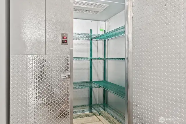 A large commercial walk-in cooler with shelving.