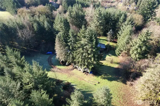 Aerial view of 40 acres with a home and barn. Country living while being close to La Center city limits. Easy I-5 access, plenty of wildlife with timber management in place, boarders Jenny Creek.