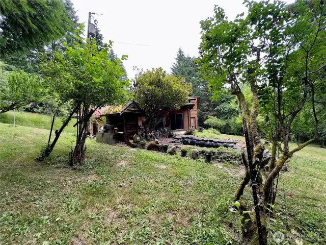 Side yard and view towards pond of the single level home at 818 NW 349th St, La Center WA in Clark County