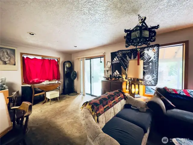 Looking from the family room towards the dining area and slider to the patio area of the single level home at 818 NW 349th St, La Center WA in Clark County.