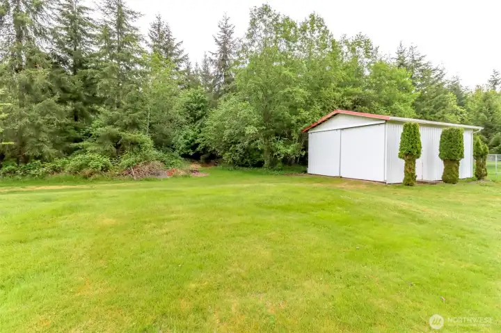 Metal shop sits at the front corner of the property.