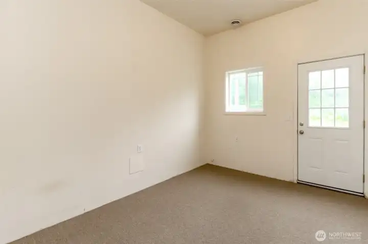 Garage office space has window and door to exterior.