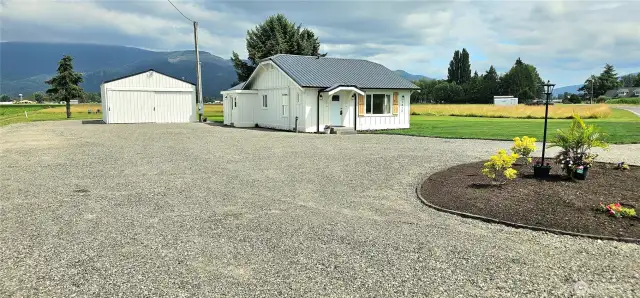 Amazing parking area for guests and toys! driveway. RV parking next to the shop as well as behind it. RV power plug is in and ready to go.