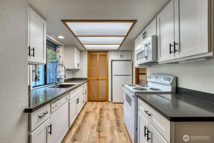 Unit A Kitchen - Recently Remodeled, New Cabinets, Countertops, Sink, Stove, Microwave, and Refrigerator