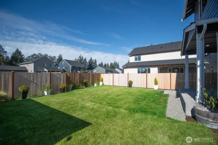 FULLY FENCED BACKYARD WITH 2 GATES AND BACK PATIO