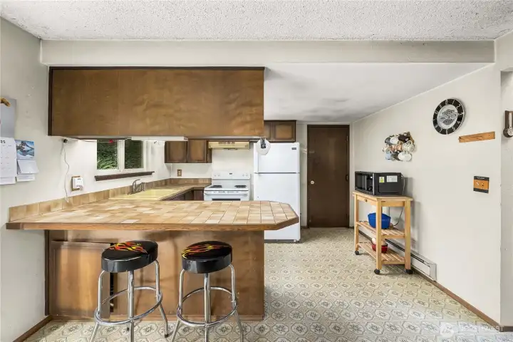 Kitchen leads to the attached garage with washer and dryer.